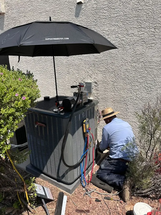 HVAC technician performing outdoor AC maintenance in Bargersville