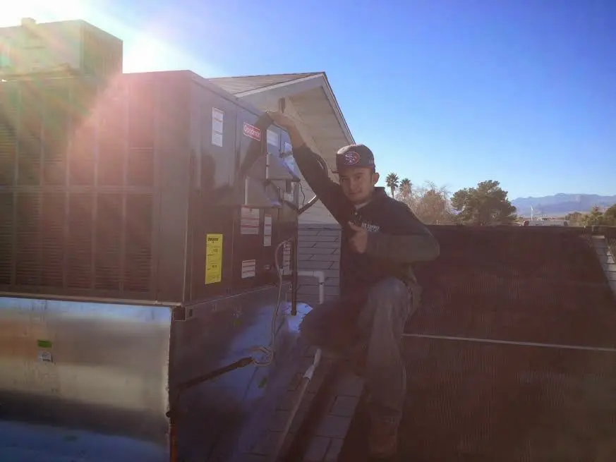HVAC technician performing Heat Pump Repair on a rooftop unit in Bargersville